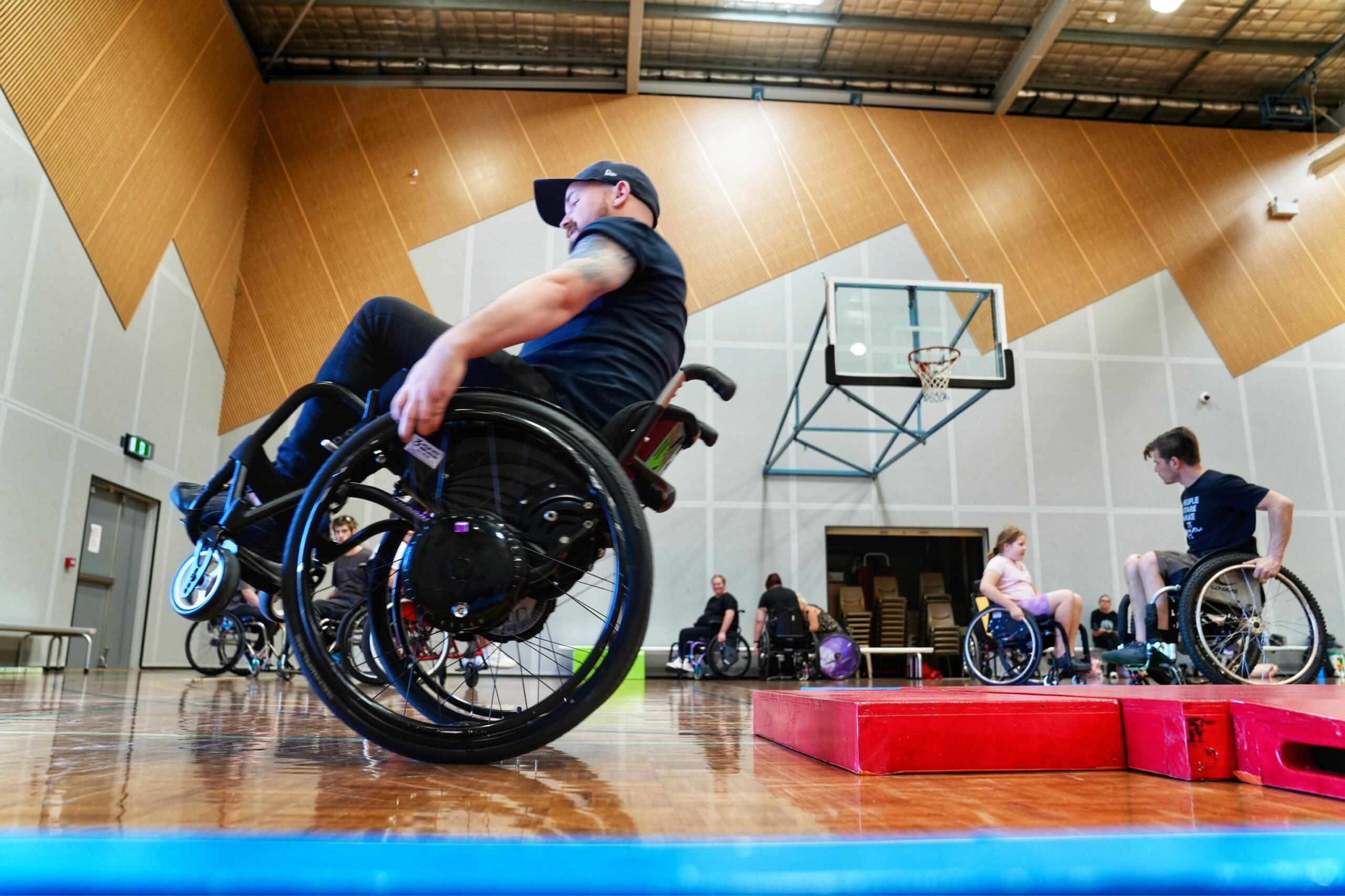 Jack O'Keeffe, a manual wheelchair user, popping a wheelie in his manual chair.